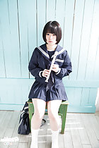 Kogal seated on chair wearing uniform holding recorder